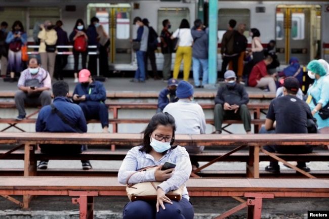 Orang-orang yang memakai masker pelindung duduk pada jam sibuk di stasiun kereta api di tengah wabah COVID-19 di Jakarta, 13 September 2021. (Foto: REUTERS/Ajeng Dinar Ulfiana)