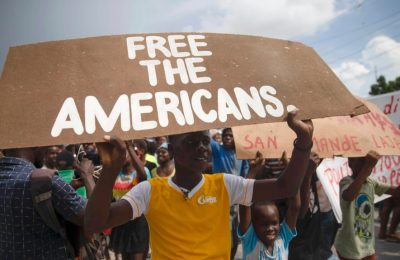 Para pengunjuk rasa menuntut pembebasan 17 warga AS dan Kanada, yang tergabung dalam sebuah kelompok misionaris Kristen, yang diculik oleh geng kriminal di Haiti, dalam sebuah aksi protes di Port-au-Prince pada 19 Oktober 2021. (Foto: AP/Joseph Odelyn)