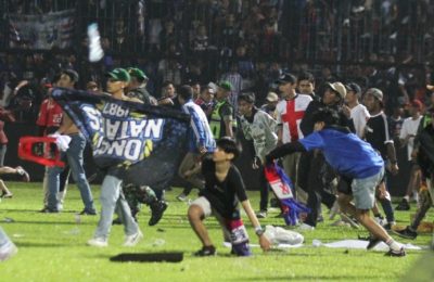 Suporter Arema FC memasuki lapangan usai tim yang mereka dukung kalah dari Persebaya usai pertandingan sepak bola liga BRI Liga 1 di Stadion Kanjuruhan, Malang, Jawa Timur, 2 Oktober 2022. (Foto: Antara/Ari Bowo Sucipto via REUTERS)