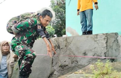 Babinsa Sertu Taufik Hadi Gendong Korban Tanah Longsor. (Ist)